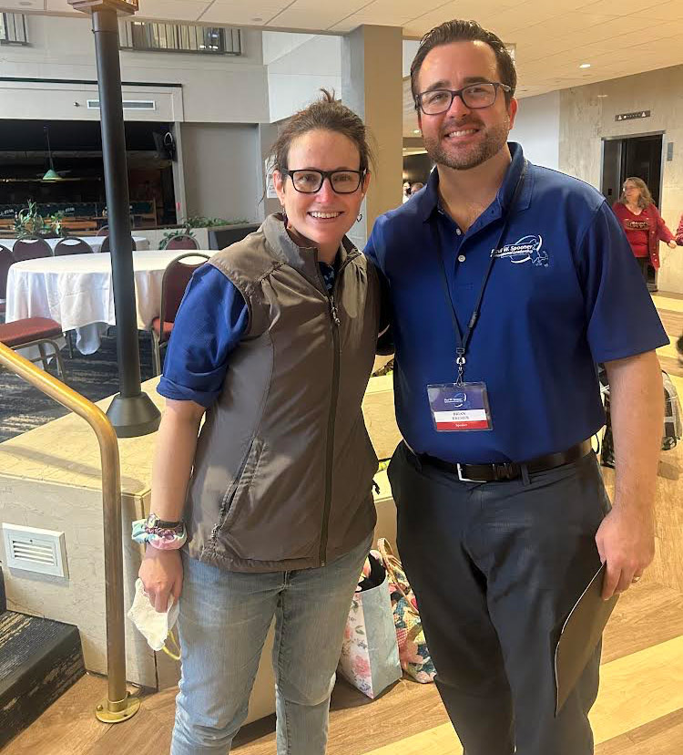 A man and a woman standing in a hotel lobby.