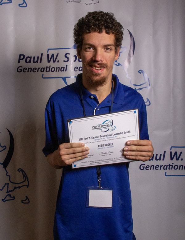 A young man holding a participation certificate.